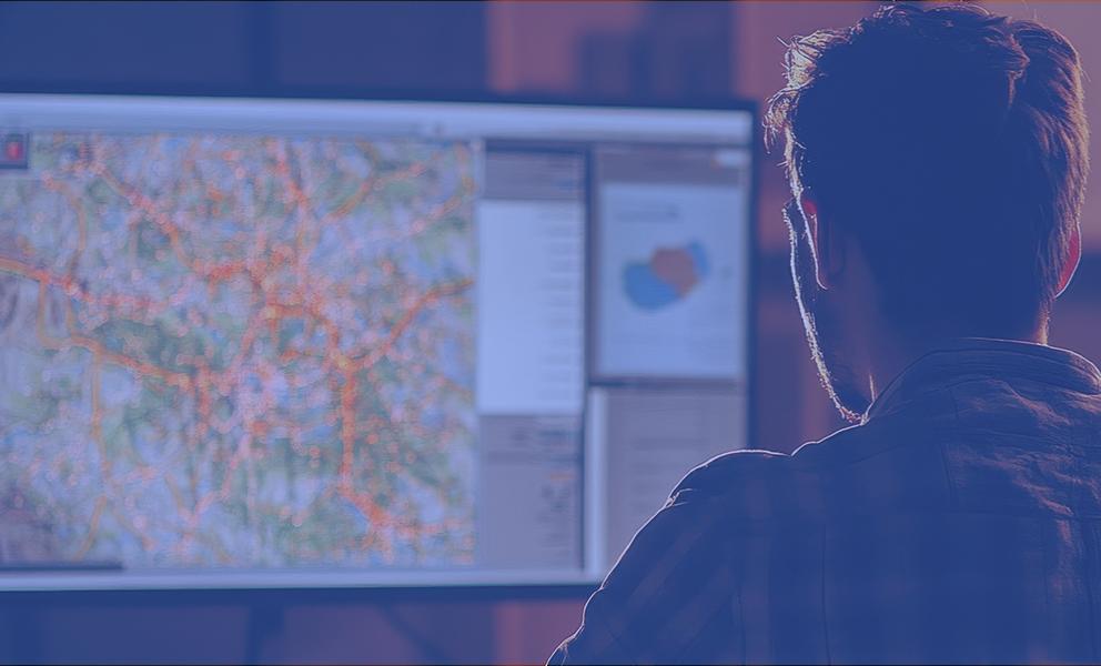 Man looking at map dashboard on computer